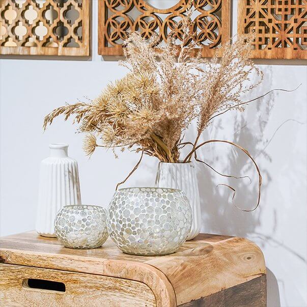 Elegant display of dried flowers in decorative vases, showcasing a stylish home decor arrangement.
