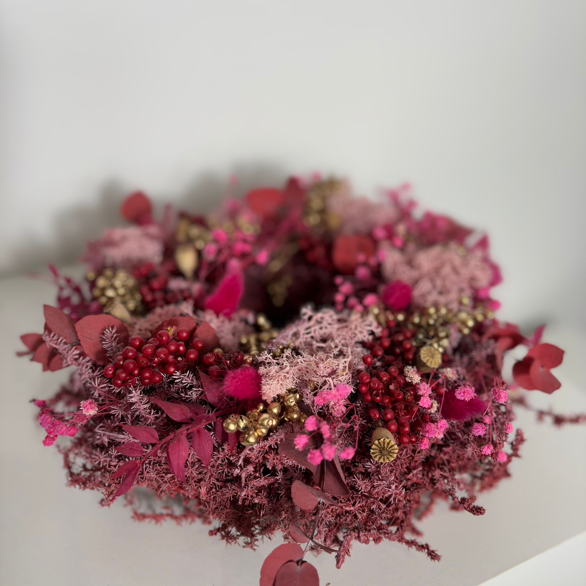 Advent wreath red made of dried flowers - pink