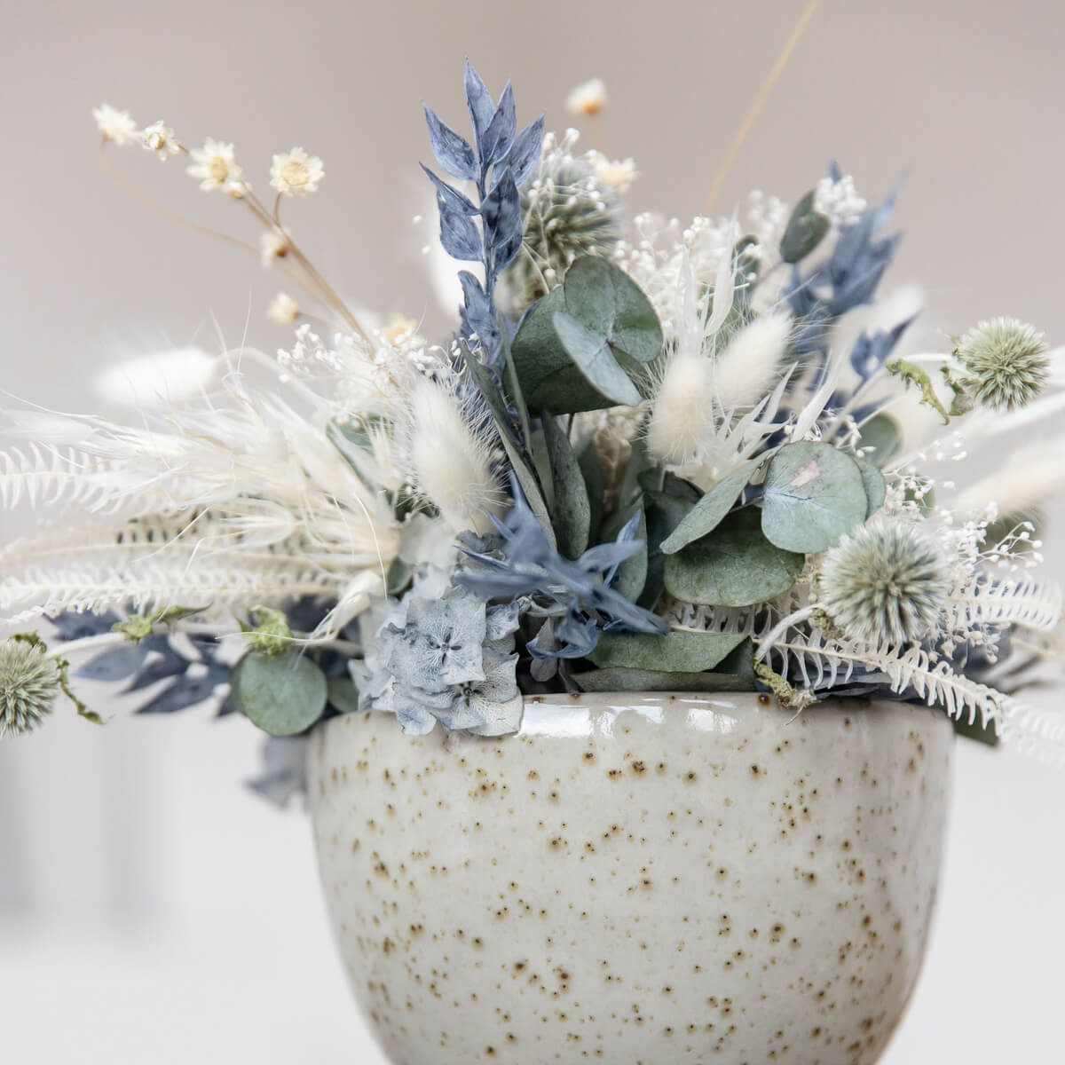 Elegance in blue and white: dried flower arrangement with eucalyptus